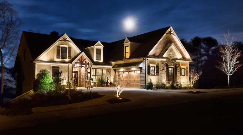 brown home with exterior lighting